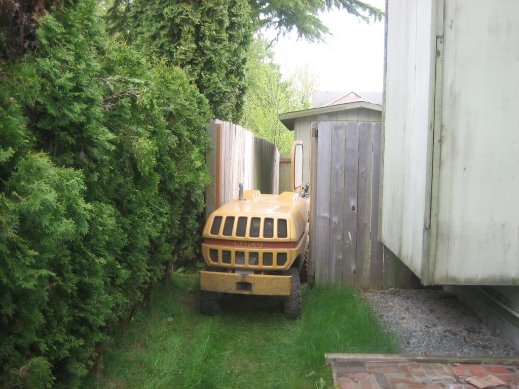 Stump grinder accessing a backyard through a narrow 36 inch gate
